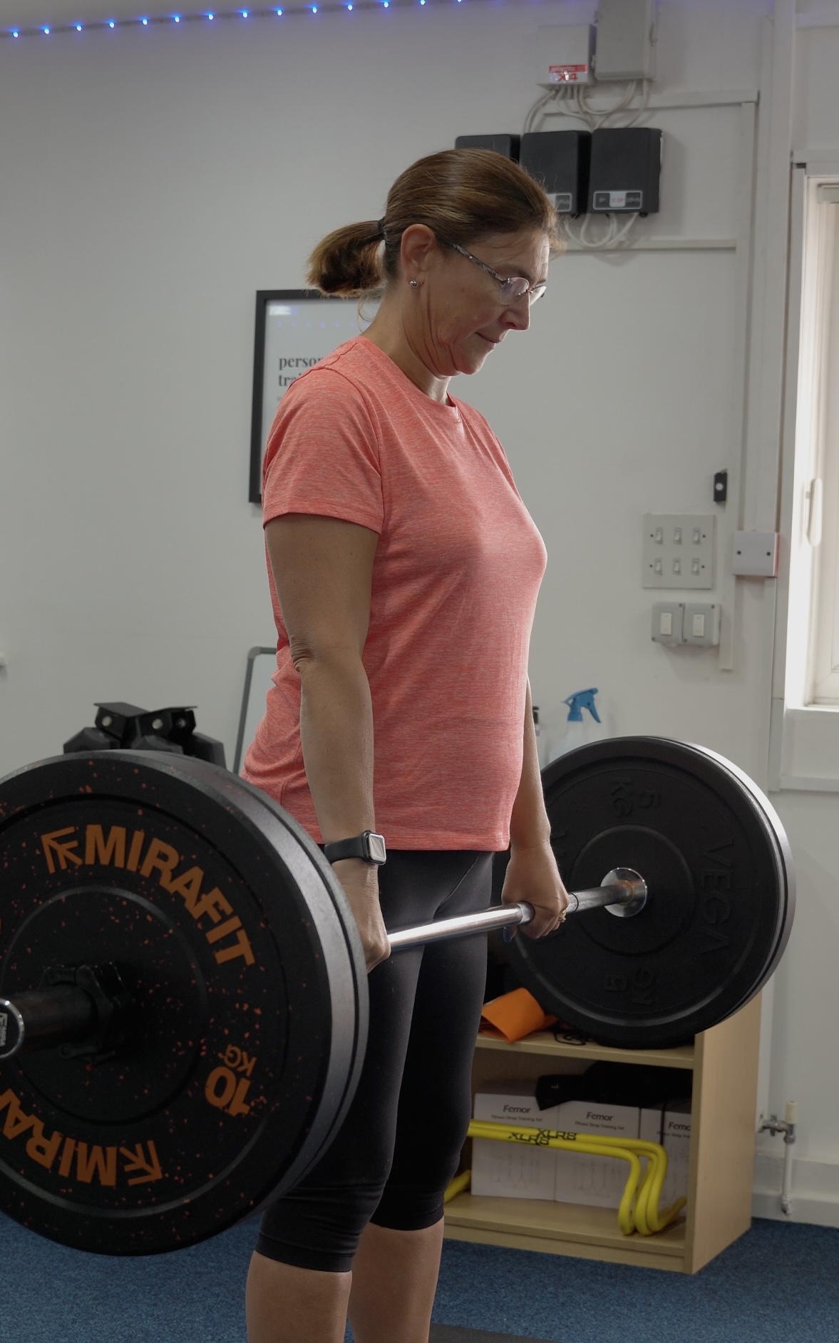 Client rowing in front of the Coached By Jack Rivers sign